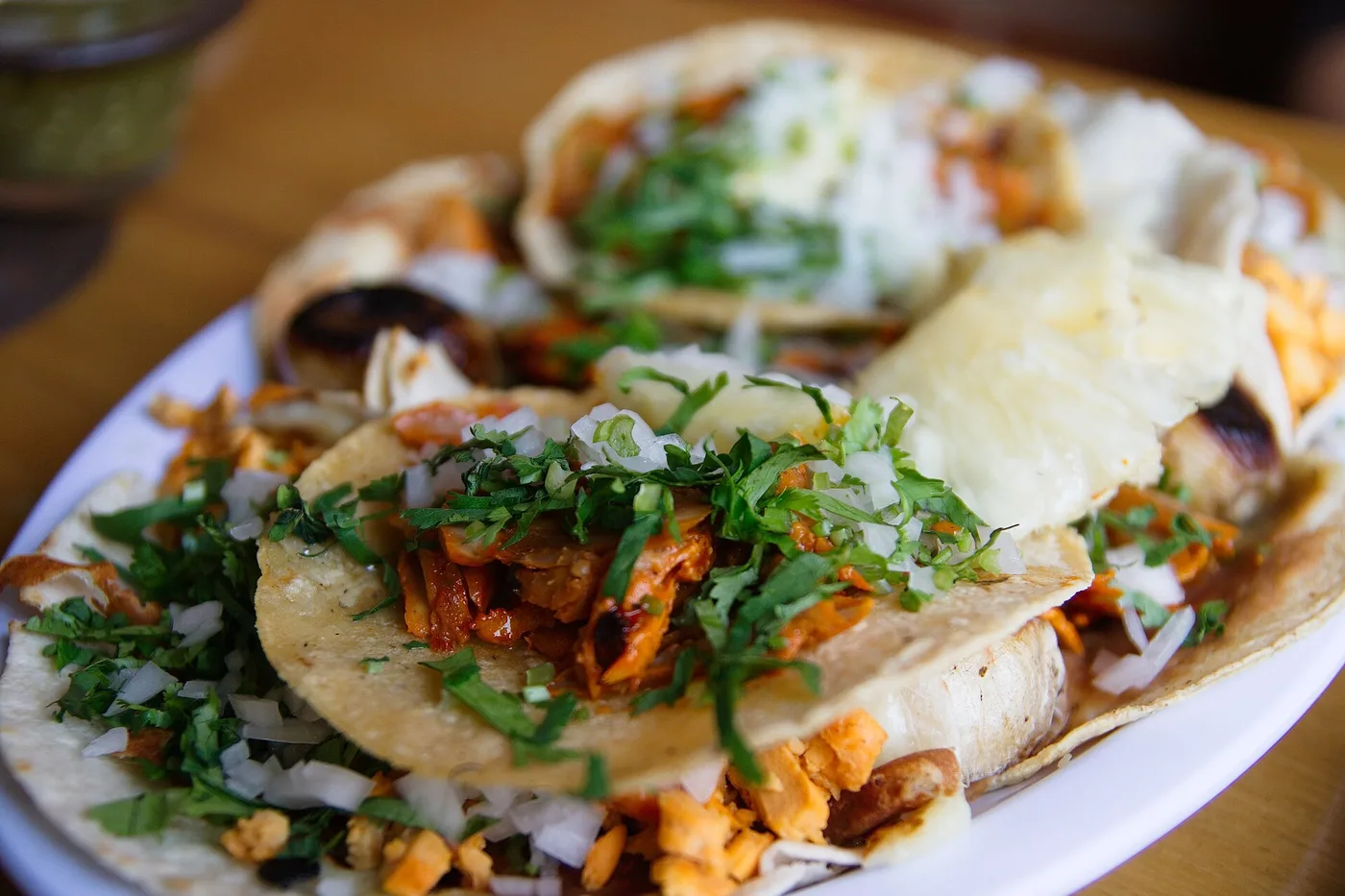 A plate of tacos al pastor with onion and cilantro. The photo was not taken at a Jacksonville restaurant.