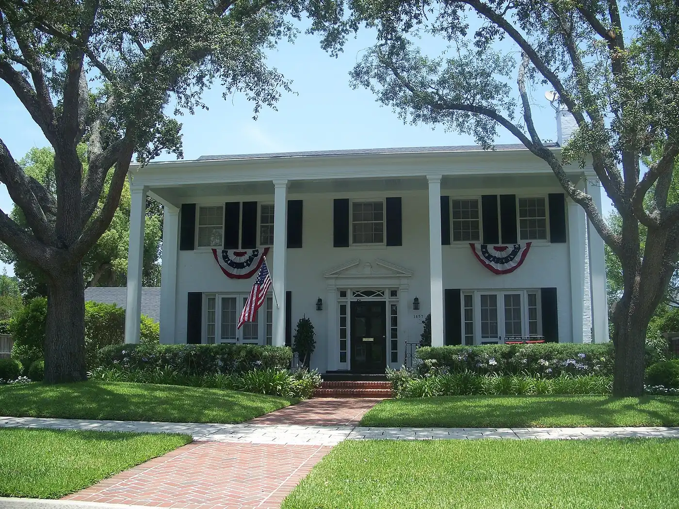 A white two-story house with columns and a brick walk in the Avondale Historic District, Jacksonville