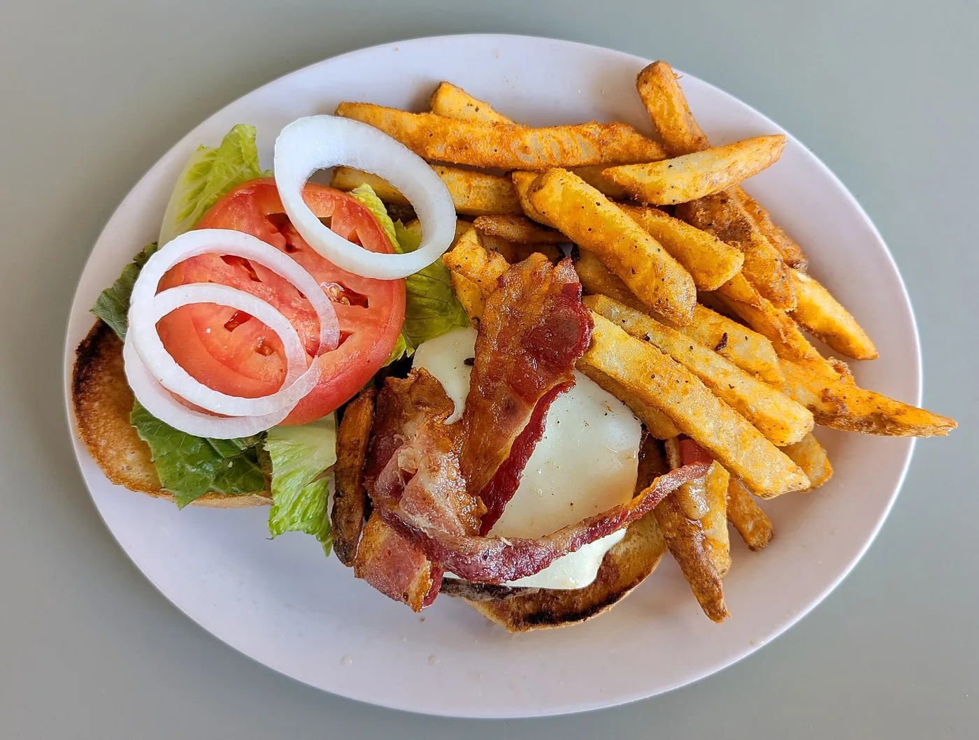 A bacon cheeseburger with fries. The photo was taken at a Massachusetts diner, not at a Jacksonville restaurant.