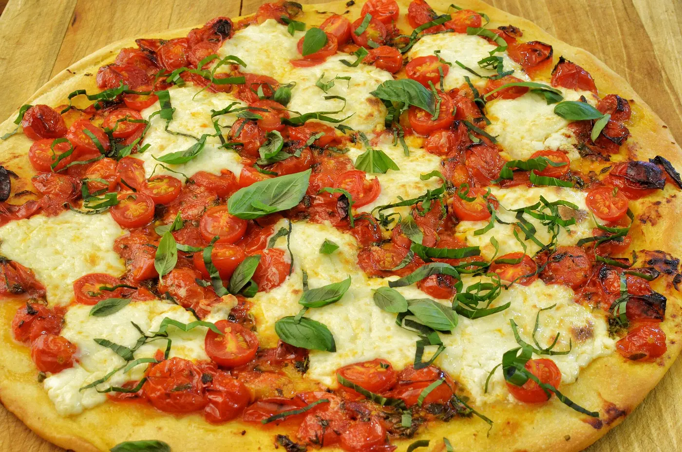 A margherita pizza with cherry tomatoes, mozzarella and basil. The photo was not taken at a Jacksonville restaurant.